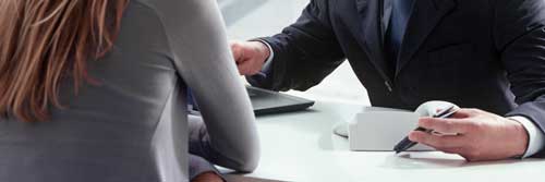 Trimnal & Myers, two businesspeople sitting at desk